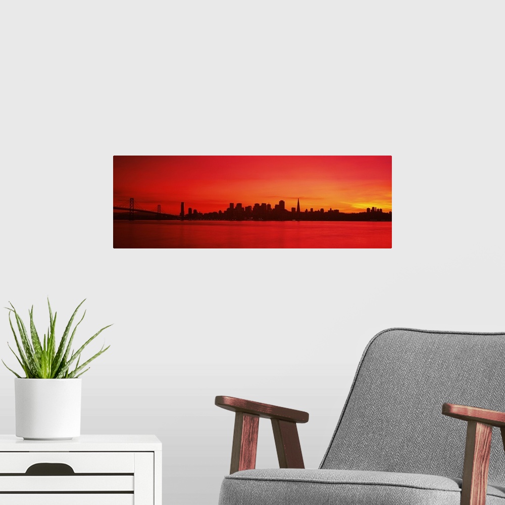 A modern room featuring Panoramic photograph of iconic suspension overpass and skyline at waterfront at sunset.