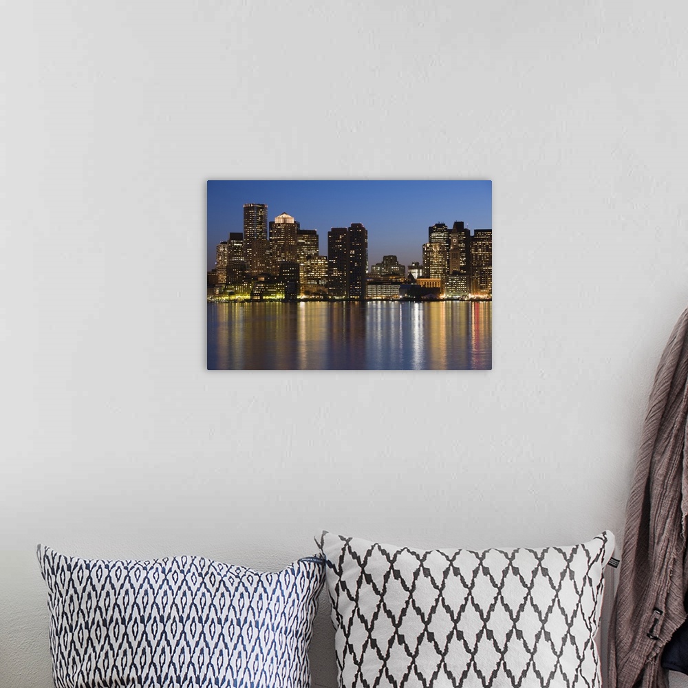 A bohemian room featuring The evening city lights create a blurred reflection in the bay in New England, the darkened skysc...