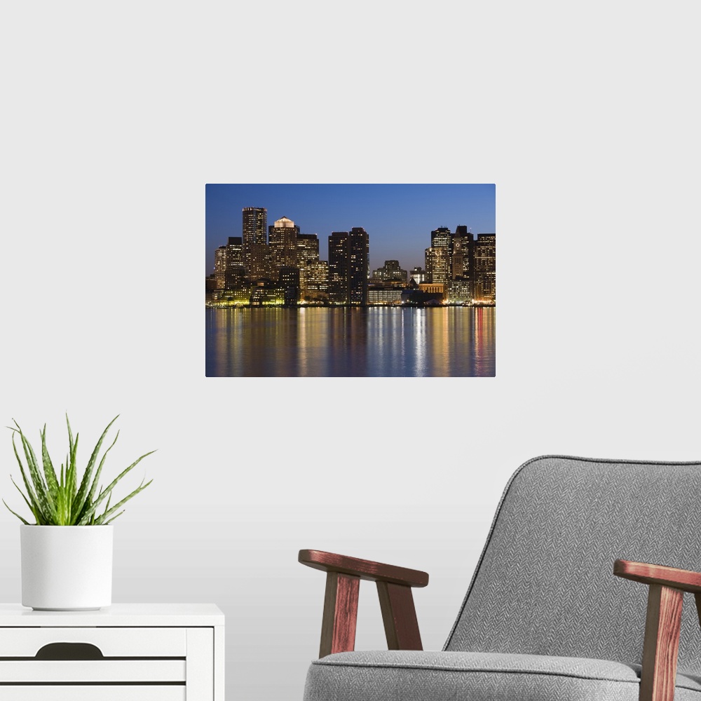 A modern room featuring The evening city lights create a blurred reflection in the bay in New England, the darkened skysc...