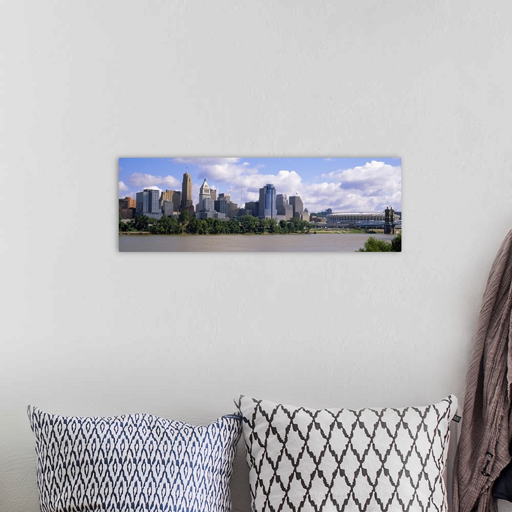 A bohemian room featuring Wide angle picture taken of the Cincinnati skyline from across the river that it sits on.