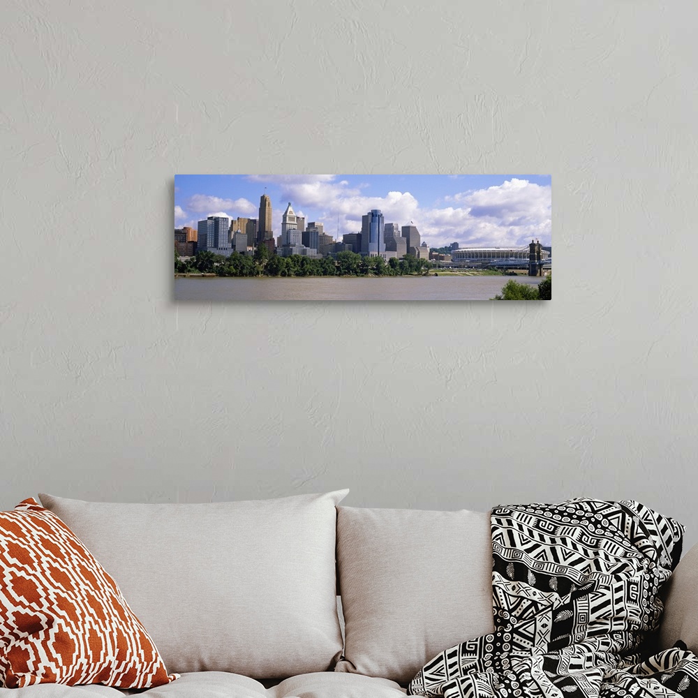 A bohemian room featuring Wide angle picture taken of the Cincinnati skyline from across the river that it sits on.