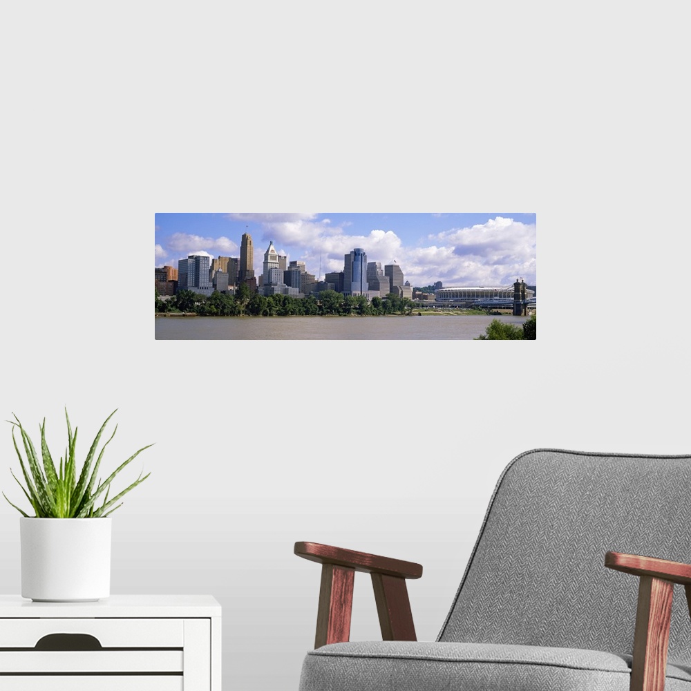 A modern room featuring Wide angle picture taken of the Cincinnati skyline from across the river that it sits on.
