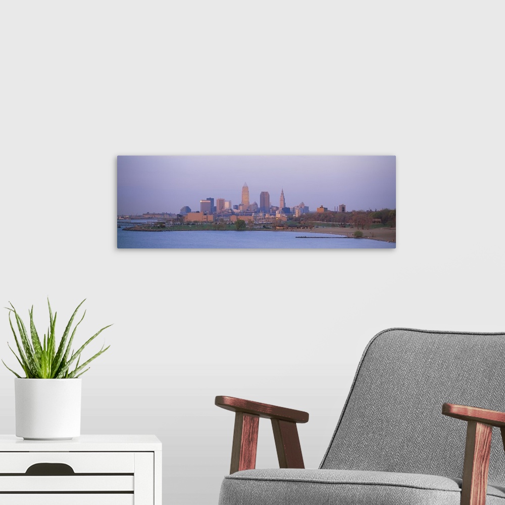 A modern room featuring The skyline in Cleveland is shot with a wide angle lens from across a body of water.