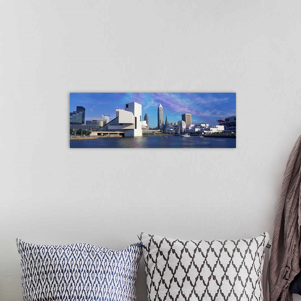 A bohemian room featuring A panoramic photograph of the city skyline built up along a river.