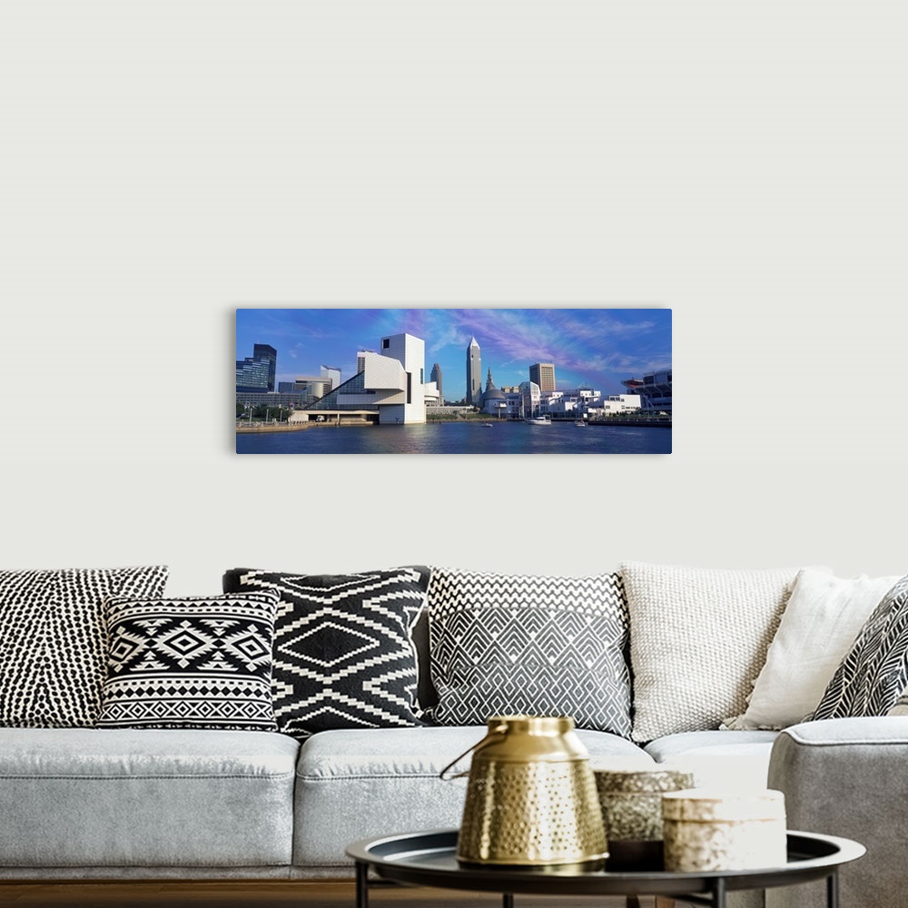 A bohemian room featuring A panoramic photograph of the city skyline built up along a river.