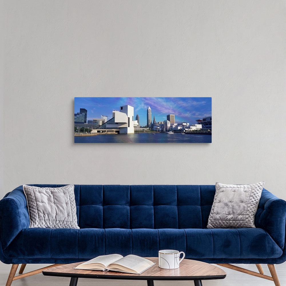 A modern room featuring A panoramic photograph of the city skyline built up along a river.