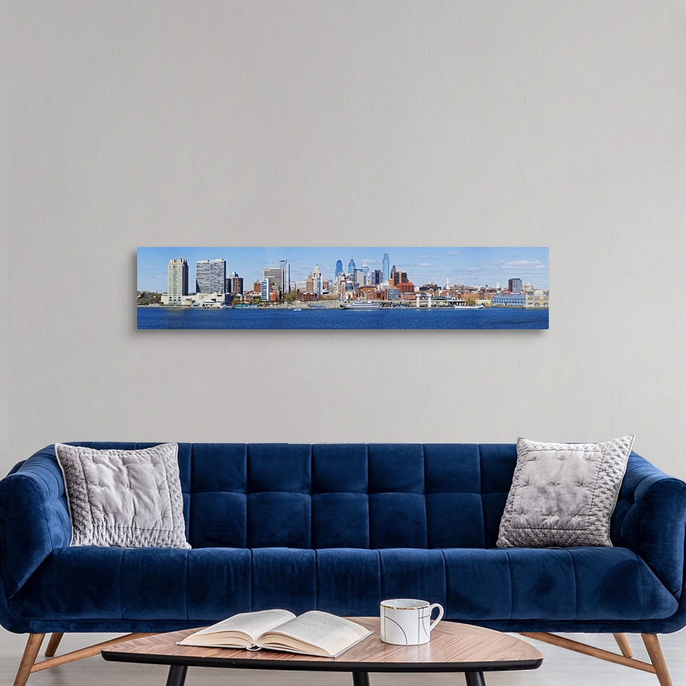 A modern room featuring A panoramic photograph taken of the Philadelphia skyline during the day from just across the Dela...