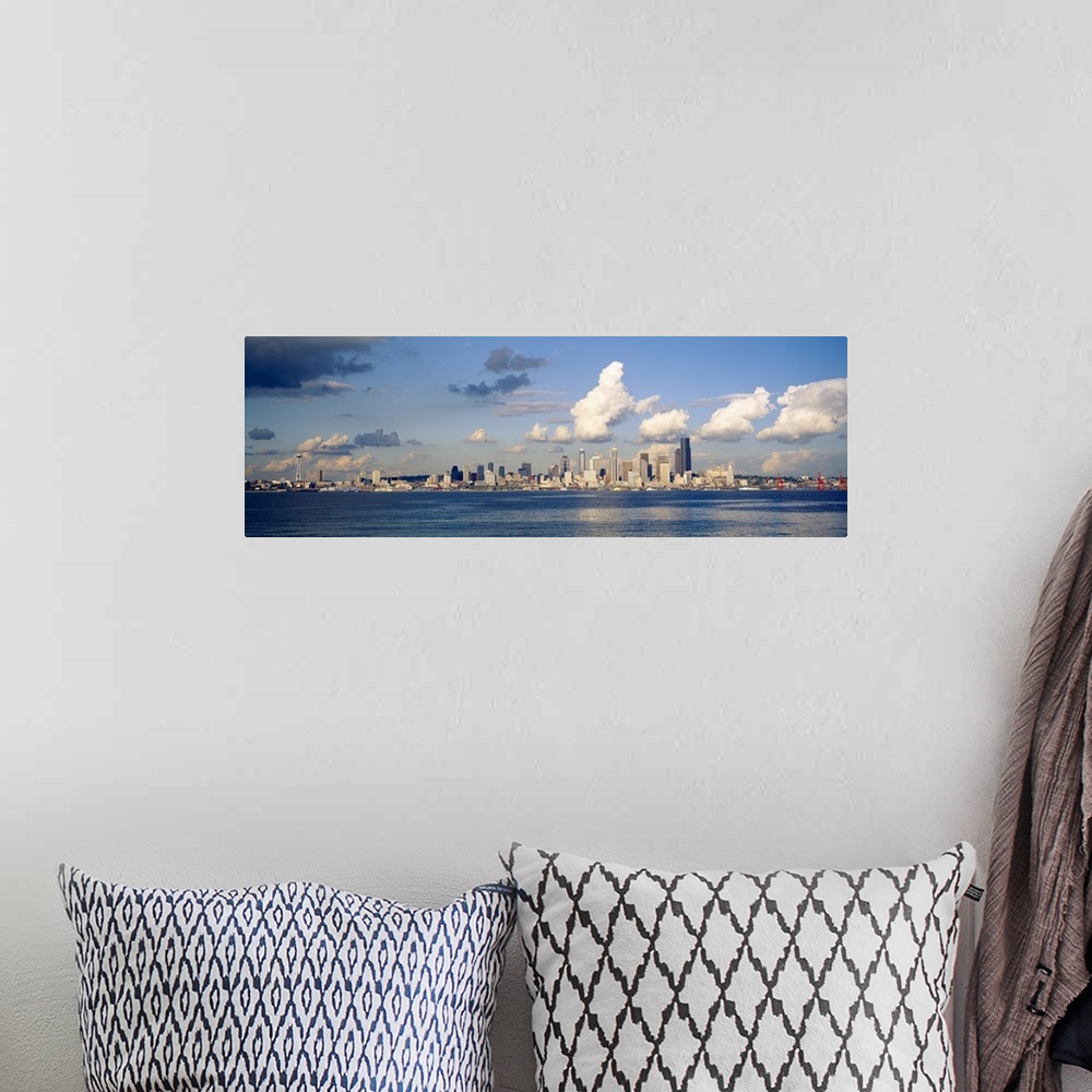 A bohemian room featuring Horizontal photograph on a large wall hanging of the Seattle skyline in the distance, Elliot Bay ...