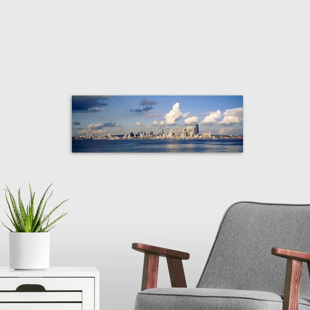 A modern room featuring Horizontal photograph on a large wall hanging of the Seattle skyline in the distance, Elliot Bay ...