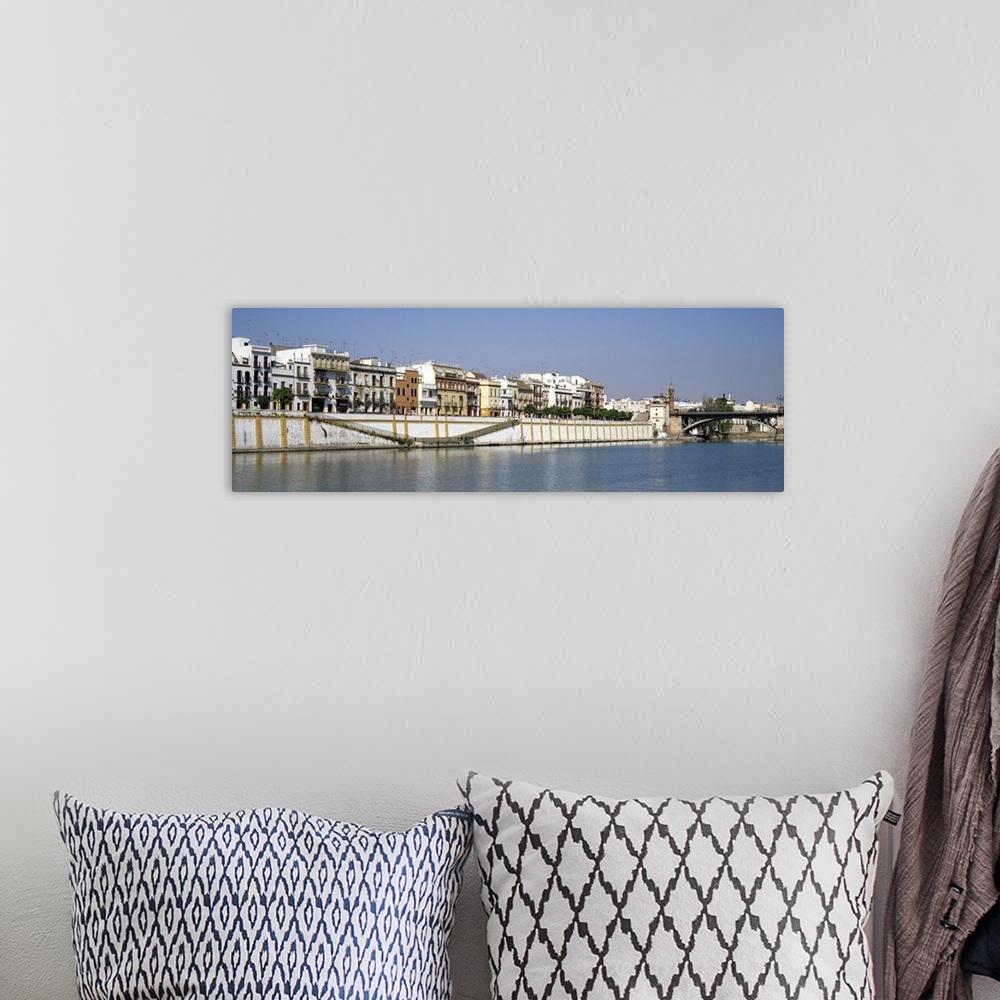 A bohemian room featuring Buildings at the waterfront, Guadalquivir River, Seville, Seville Province, Andalusia, Spain