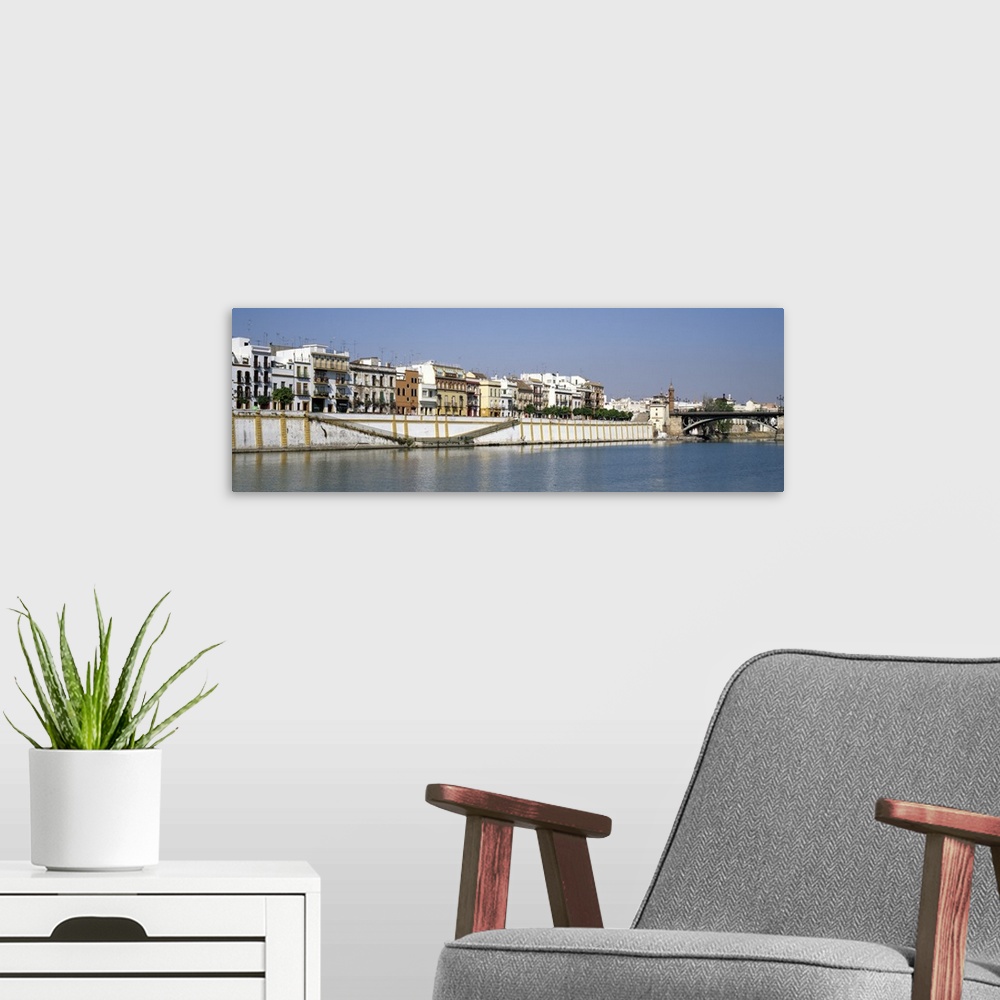 A modern room featuring Buildings at the waterfront, Guadalquivir River, Seville, Seville Province, Andalusia, Spain