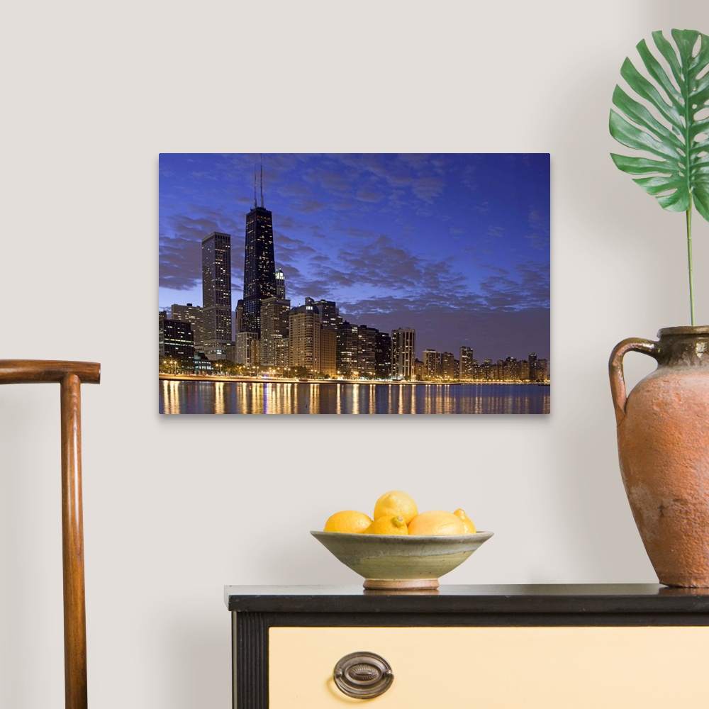 A traditional room featuring Large photo on canvas of the Chicago cityscape lit up at night reflecting into the nearby waterfr...