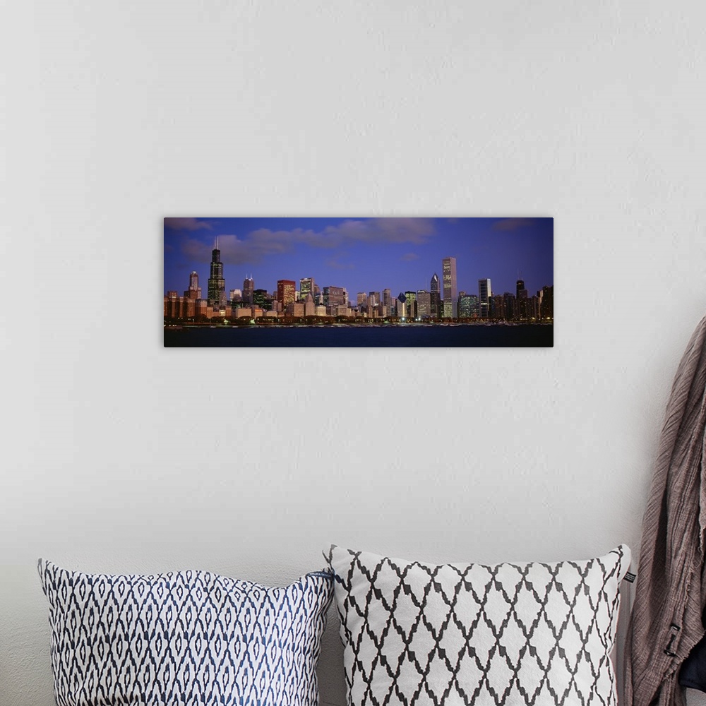 A bohemian room featuring Panoramic photograph displays the busy skyline of a famous city within the Midwestern United Stat...