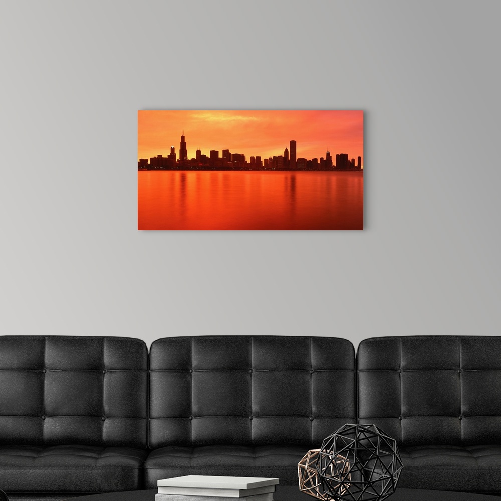 A modern room featuring Large panoramic photograph of the Chicago, Illinois (IL) waterfront at dusk with the sun's rays r...