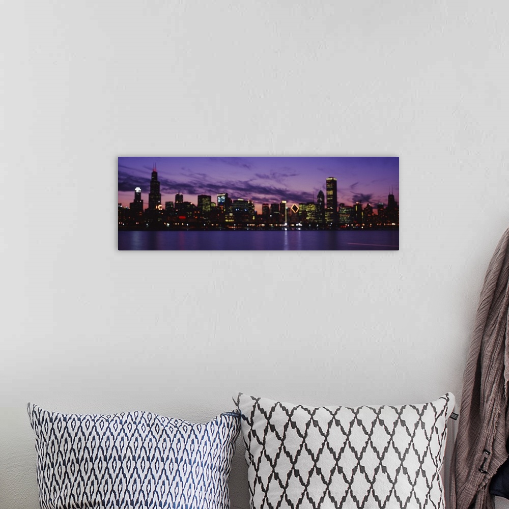 A bohemian room featuring Wide angle view of the Chicago skyline lit beneath a vibrant night sky, over the waters of Lake M...