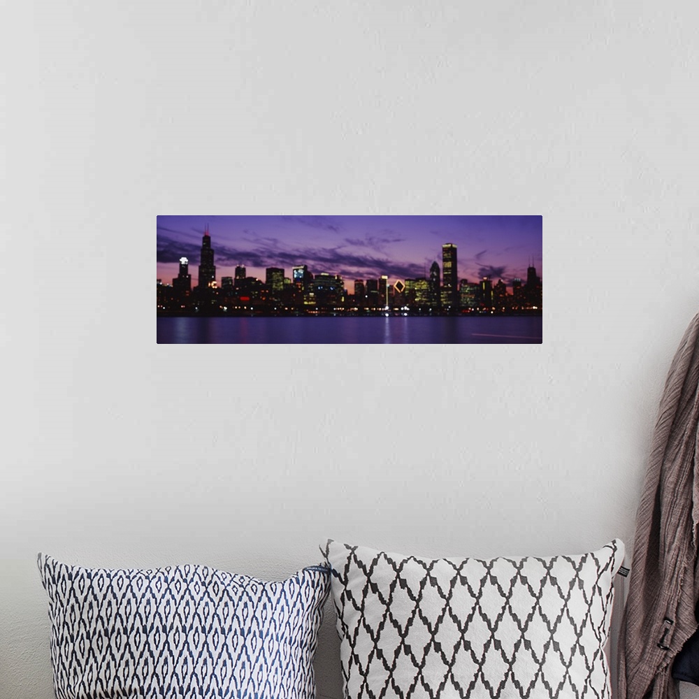 A bohemian room featuring Wide angle view of the Chicago skyline lit beneath a vibrant night sky, over the waters of Lake M...