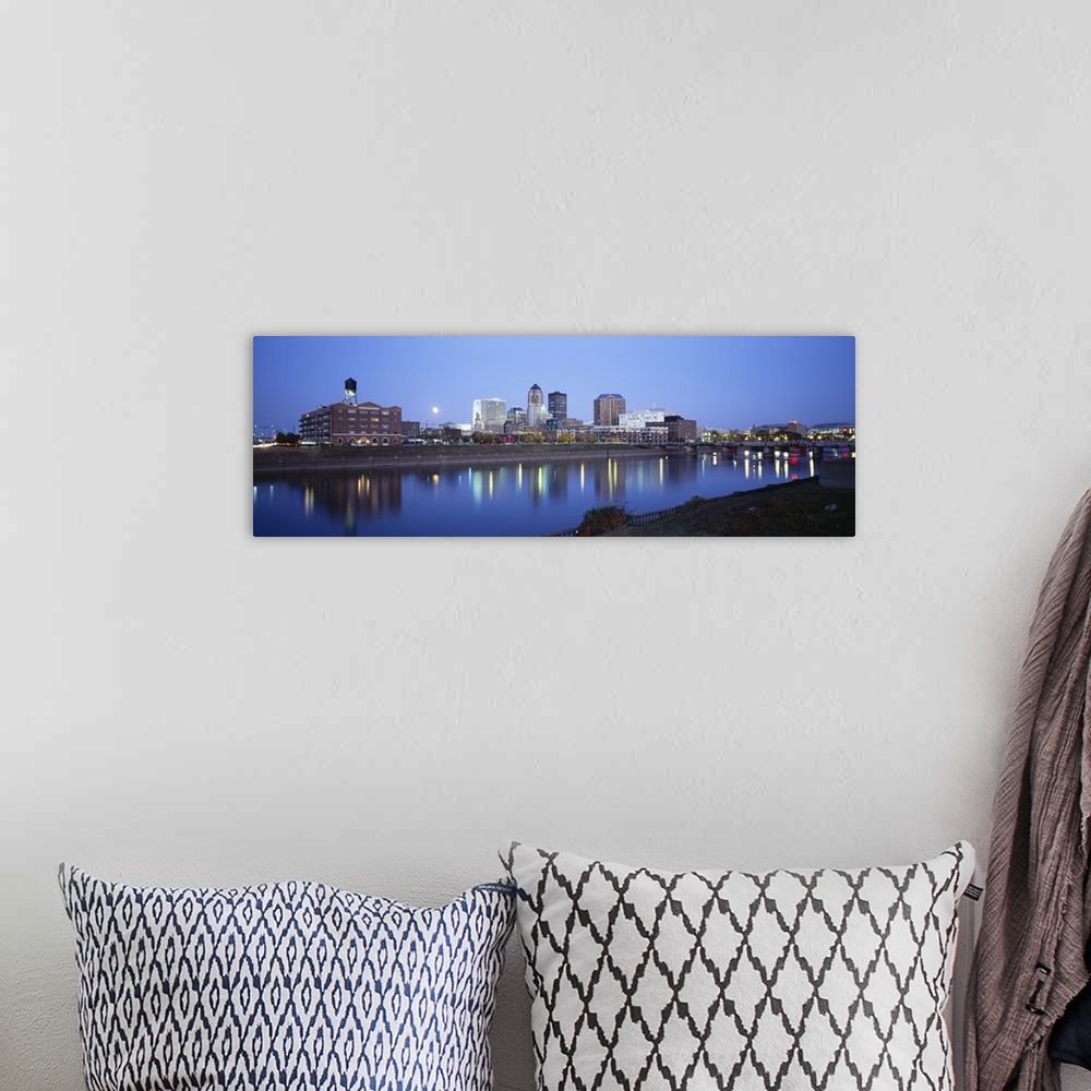 A bohemian room featuring This panoramic photograph is taken of buildings lit up at night that sit on the water front in De...