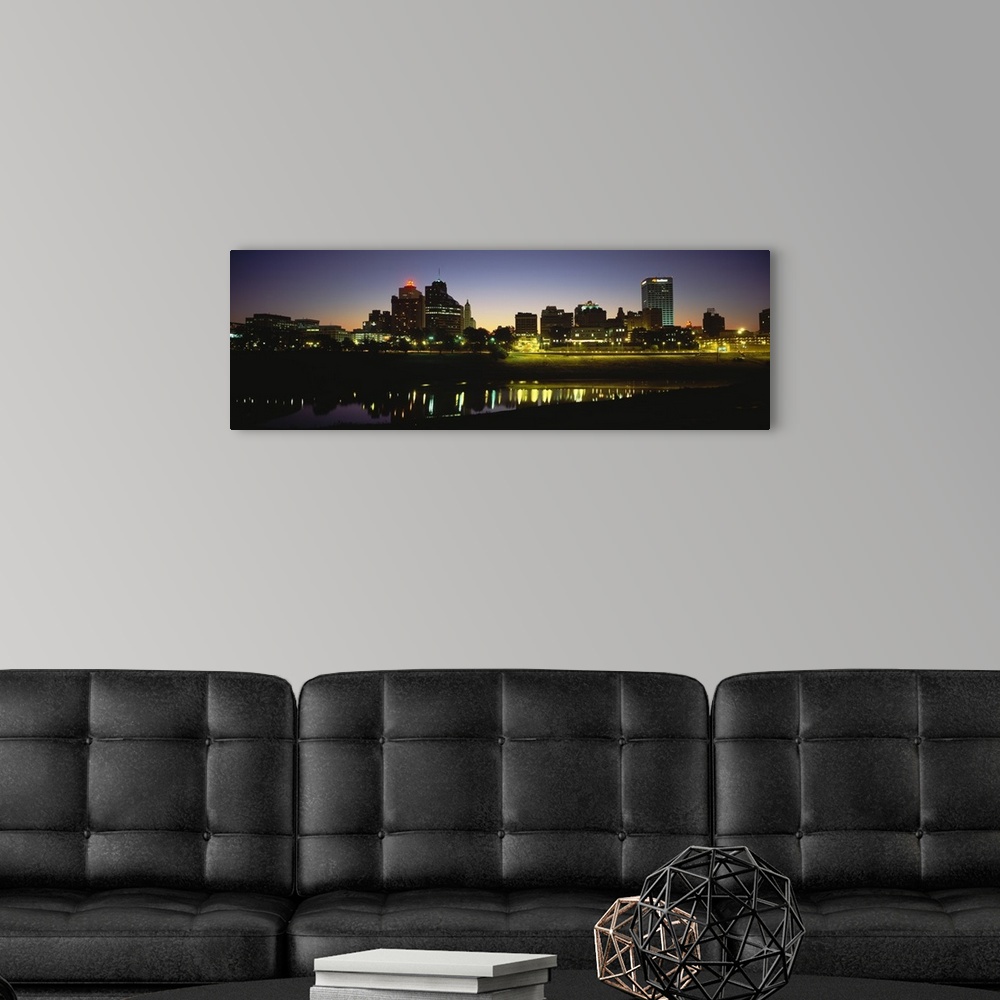 A modern room featuring Panoramic skyline of Memphis, Tennessee as the sun begins to rise over the Mississippi river.