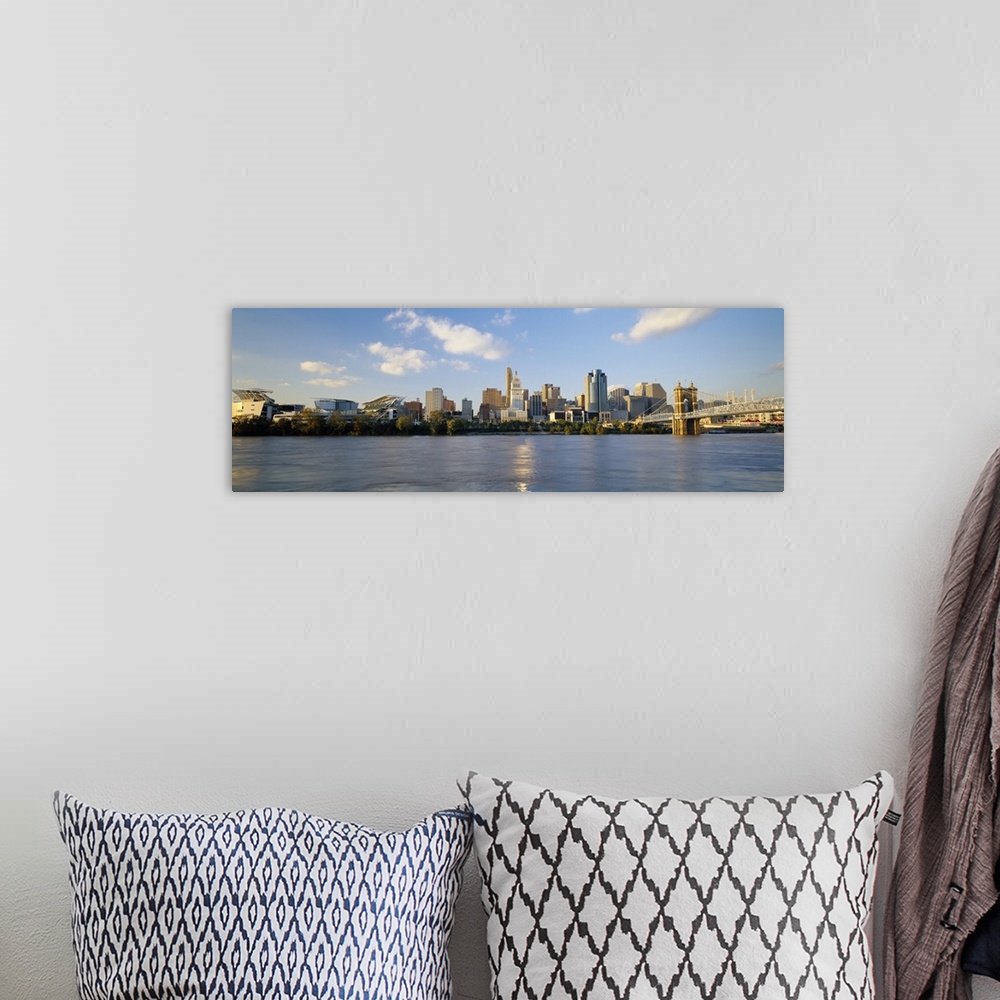 A bohemian room featuring Wide angle photograph on a large wall hanging of a distant Cincinnati skyline along the edge of t...