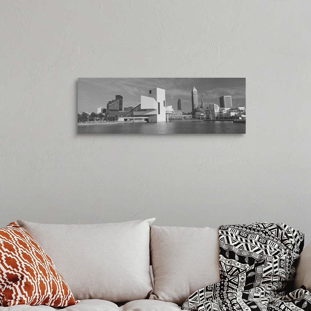 A bohemian room featuring A black and white panoramic photograph taken of buildings in Cleveland sitting on water with the ...