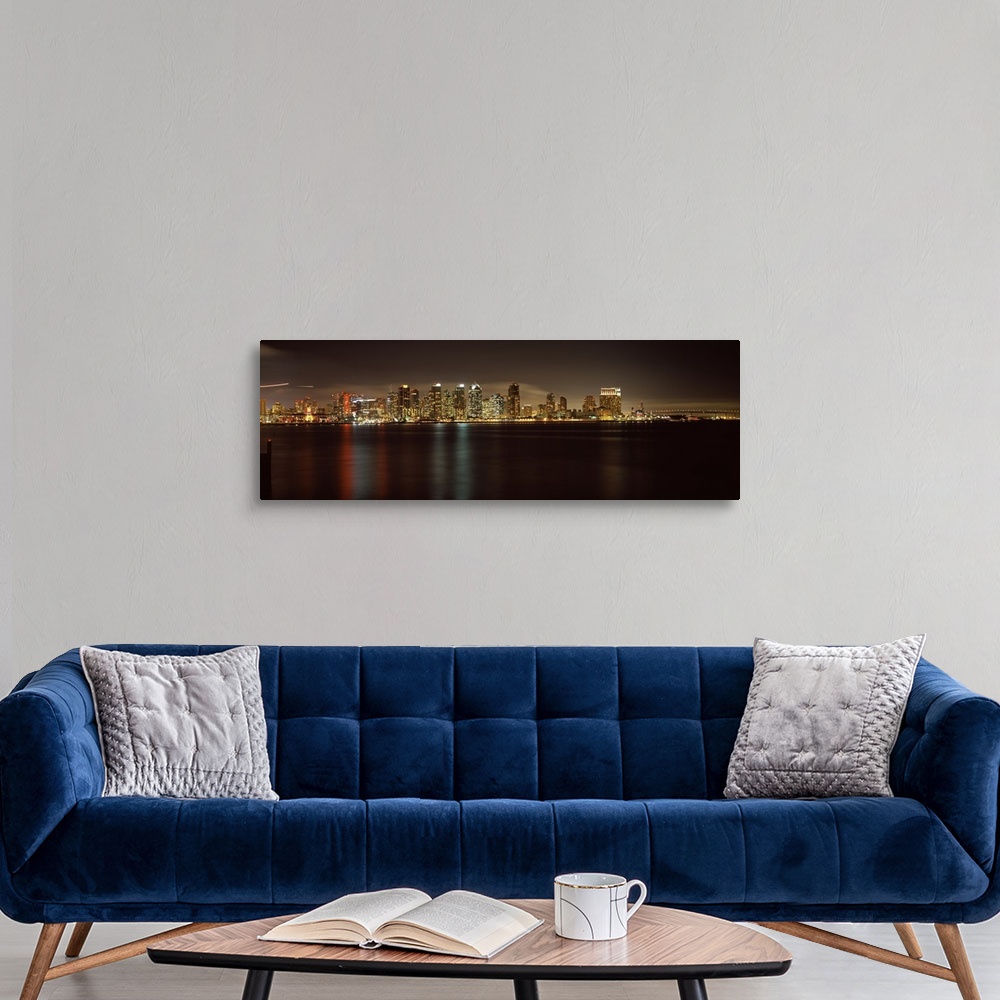 A modern room featuring Panoramic photograph of the San Diego city skyline along the edge of the bay in the evening, the ...
