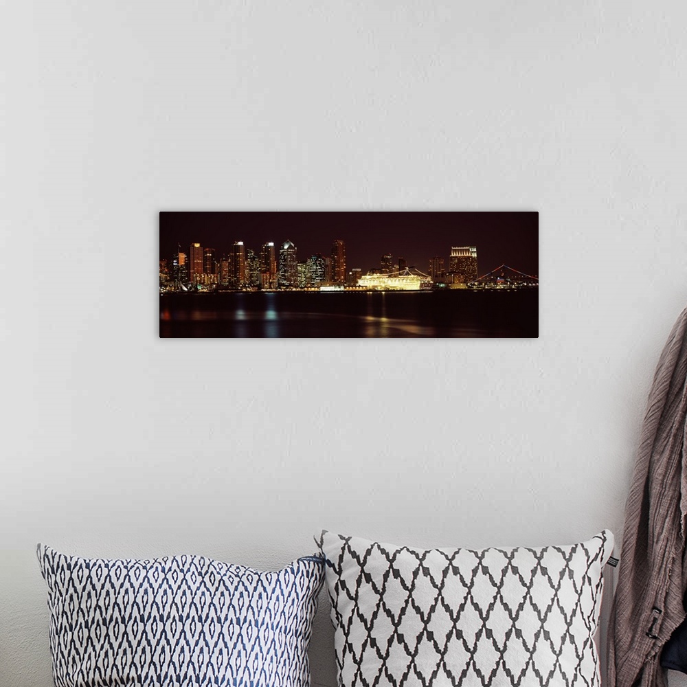 A bohemian room featuring Panoramic photograph on a big wall hanging of the San Diego skyline along the edge of the water, ...