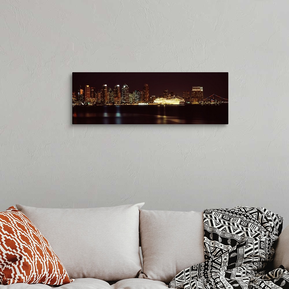 A bohemian room featuring Panoramic photograph on a big wall hanging of the San Diego skyline along the edge of the water, ...