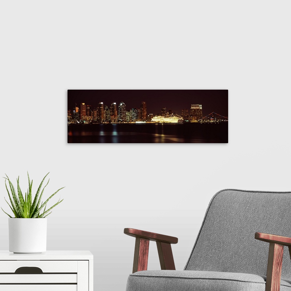 A modern room featuring Panoramic photograph on a big wall hanging of the San Diego skyline along the edge of the water, ...