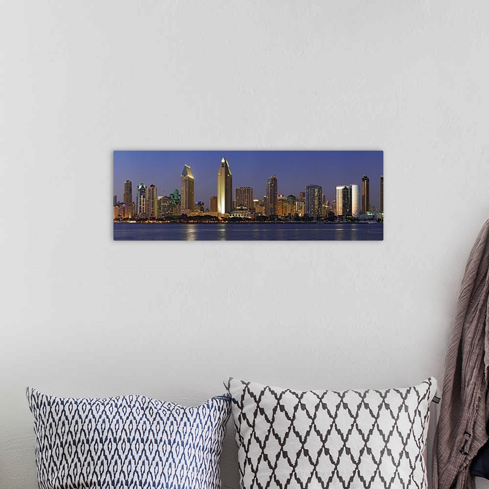 A bohemian room featuring Panoramic photograph of skyline at night with buildings lit up and reflected in the waterfront be...