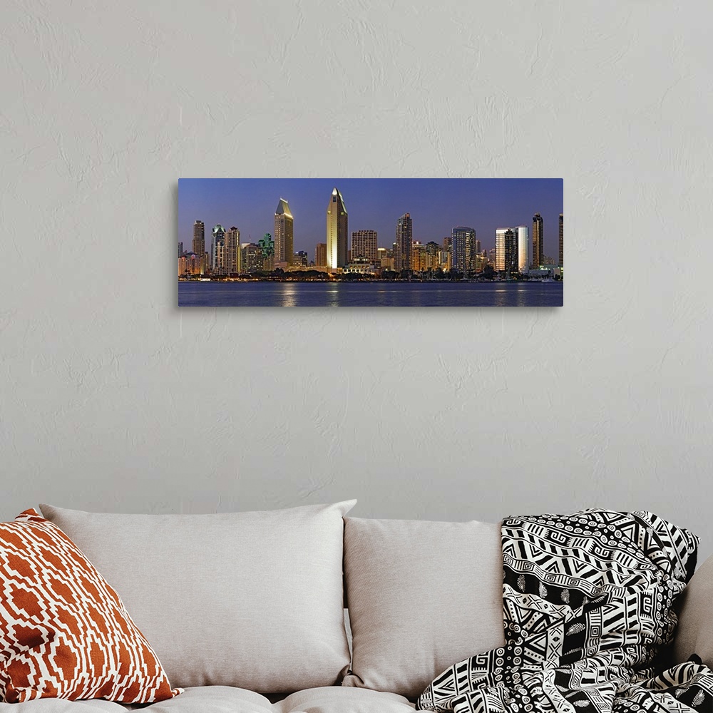A bohemian room featuring Panoramic photograph of skyline at night with buildings lit up and reflected in the waterfront be...