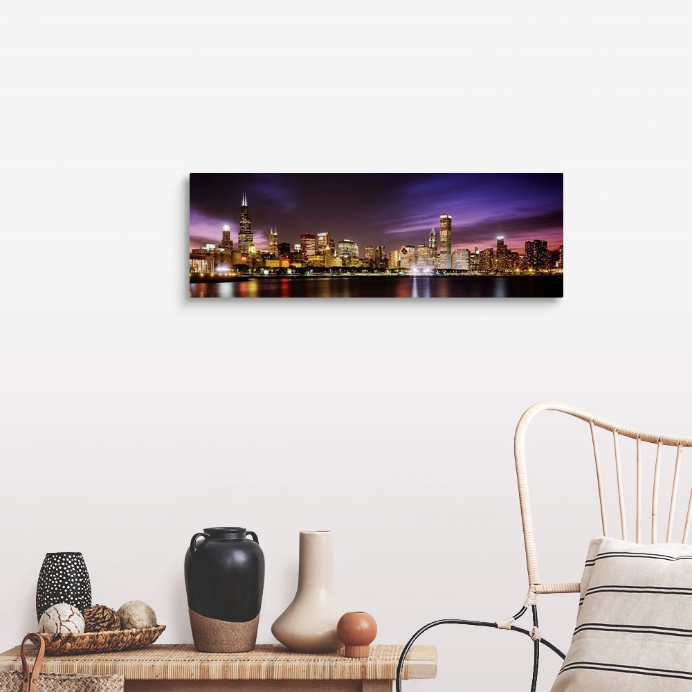 A farmhouse room featuring A big cityscape panoramic of downtown Chicagoos lights reflecting off Lake Michigan at night.