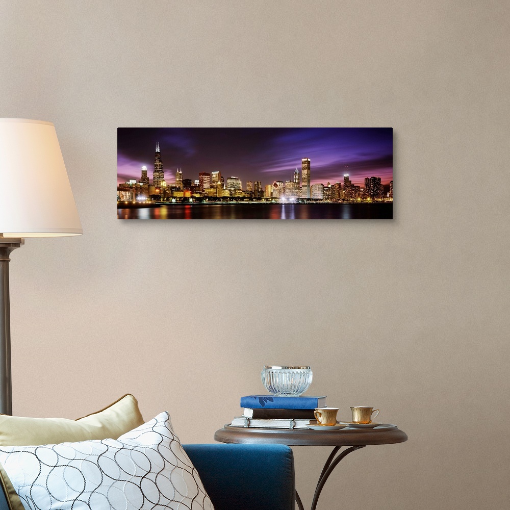 A traditional room featuring A big cityscape panoramic of downtown Chicagoos lights reflecting off Lake Michigan at night.