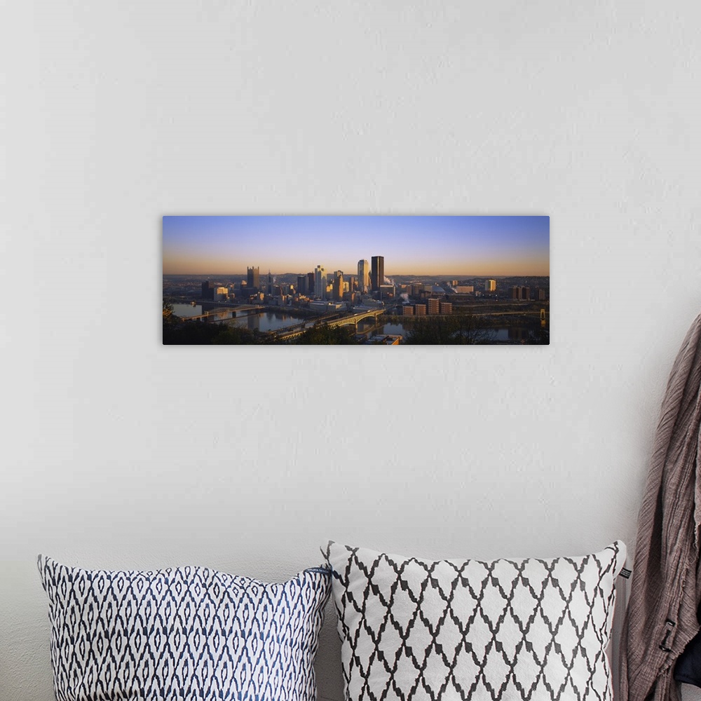 A bohemian room featuring Panoramic photograph of skyline and water front at dusk.