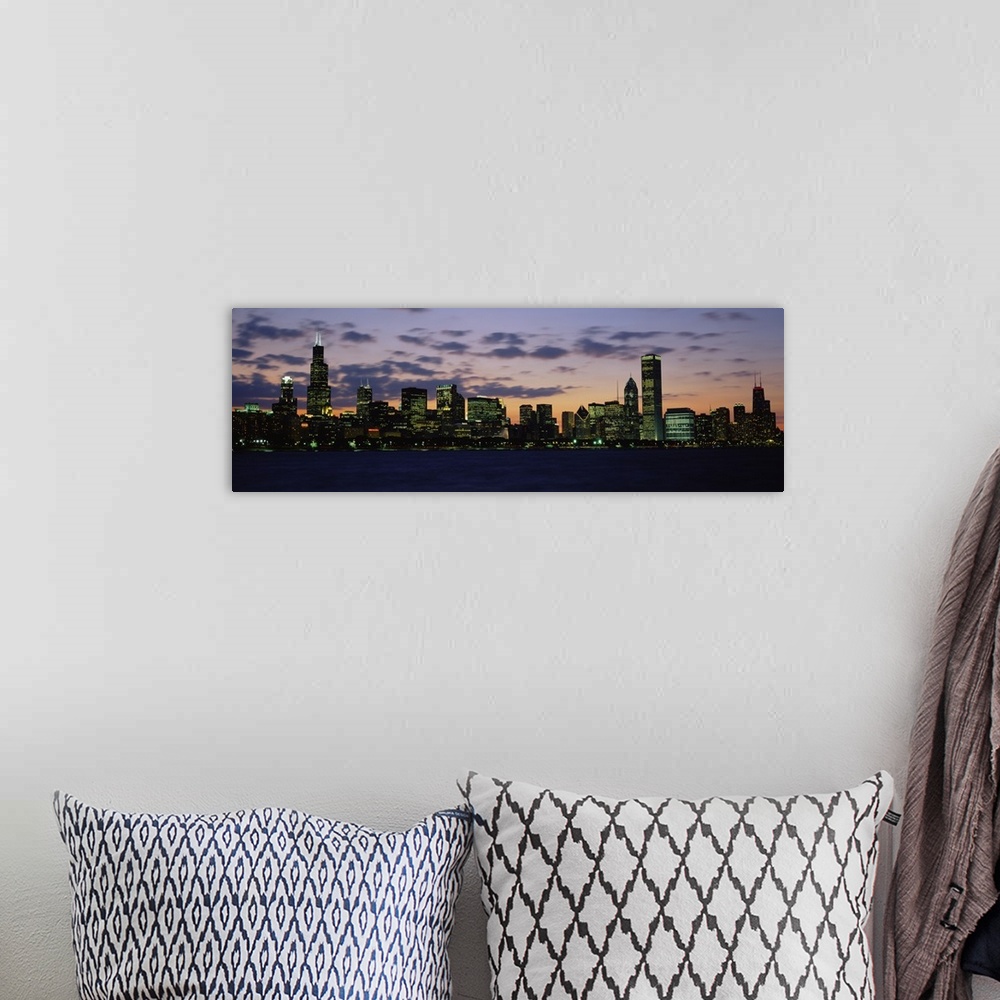 A bohemian room featuring Panoramic photograph shows a skyline on the edge of a river within a lively Midwestern city lit u...