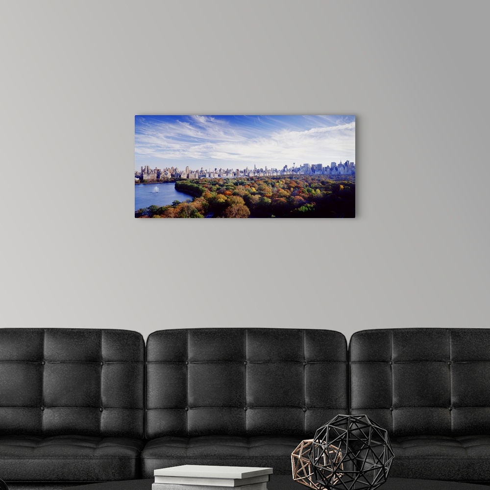 A modern room featuring NYC skyline as seen with Central Park in the foreground during the fall.