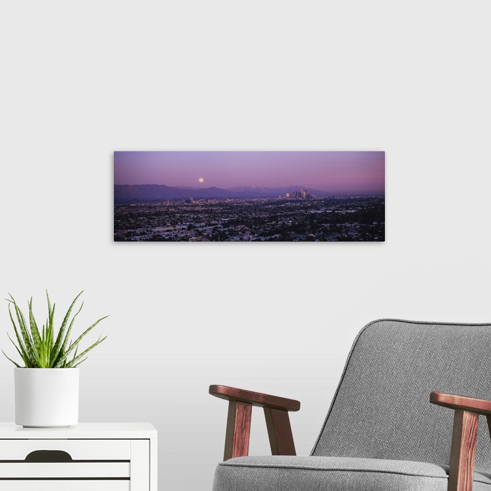 A modern room featuring An aerial photograph taken of residential areas in Los Angeles with the city far off in the dista...
