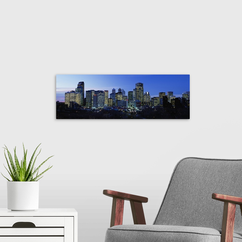 A modern room featuring Buildings in a city lit up at dusk, Calgary, Alberta, Canada