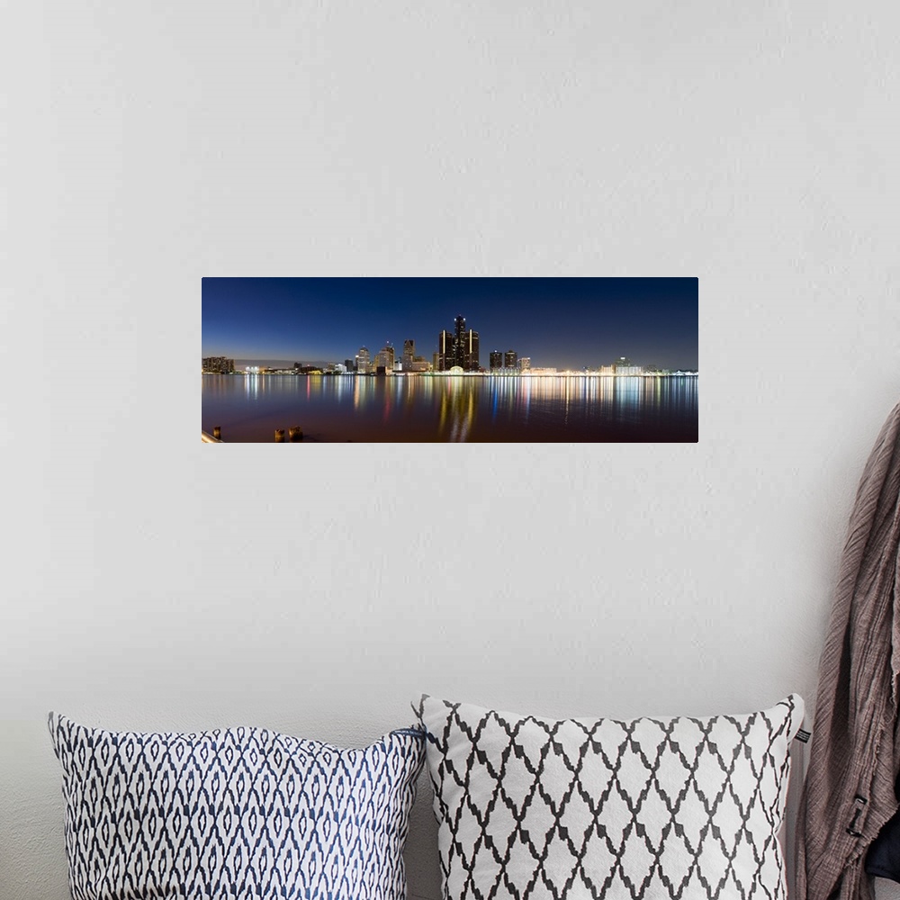 A bohemian room featuring Panoramic photograph of skyline and waterfront at night.  The building lights create colorful ref...
