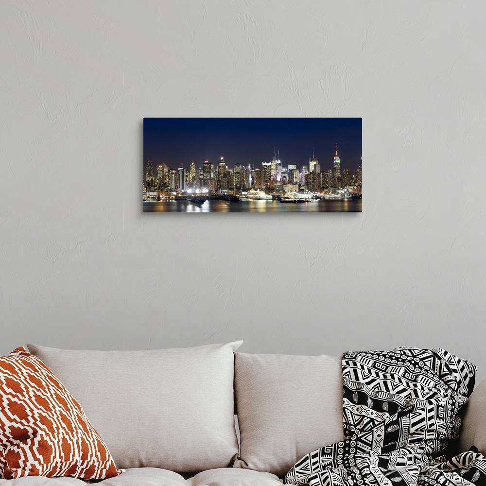 A bohemian room featuring Panoramic photograph showcases a busy skyline filled with skyscrapers as they shine brightly in t...
