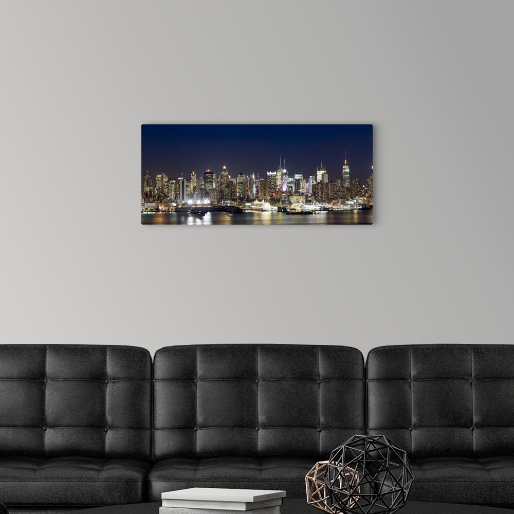 A modern room featuring Panoramic photograph showcases a busy skyline filled with skyscrapers as they shine brightly in t...