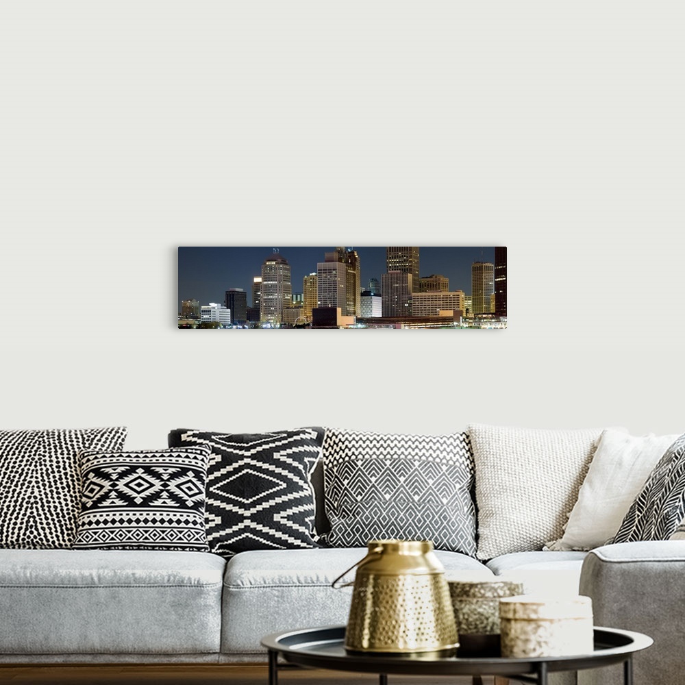A bohemian room featuring Oversize horizontal photograph of lit skyscrapers against a deep blue sky at night, in Detroit, M...