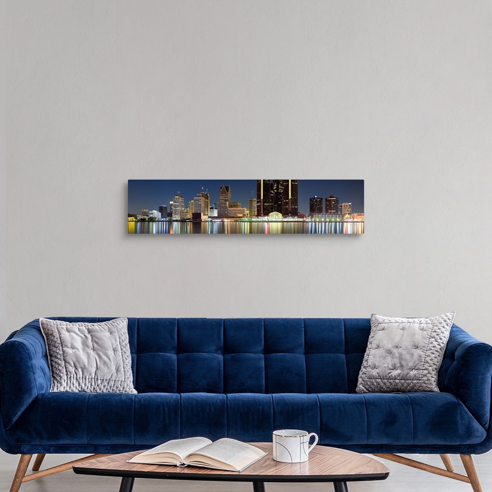 A modern room featuring Panoramic photograph of skyline after sunset with city lights reflected in waterfront.