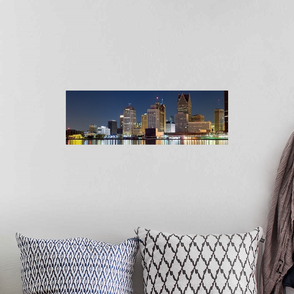 A bohemian room featuring Nighttime panoramic shot of downtown Detroit buildings lit up at night and their light reflection...