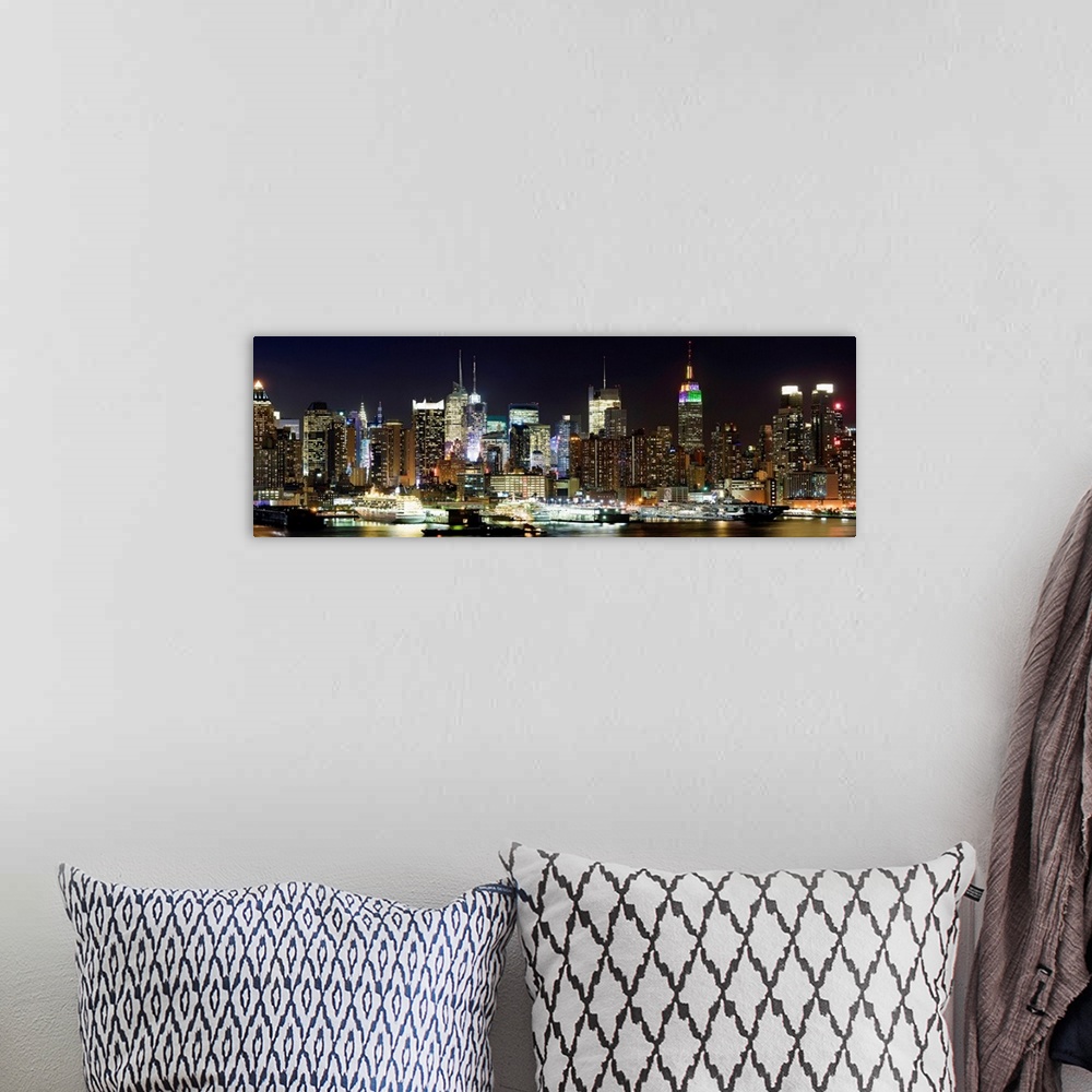 A bohemian room featuring Oversized panoramic photograph of brightly lit skyscrapers in Manhattan, behind the reflecting wa...