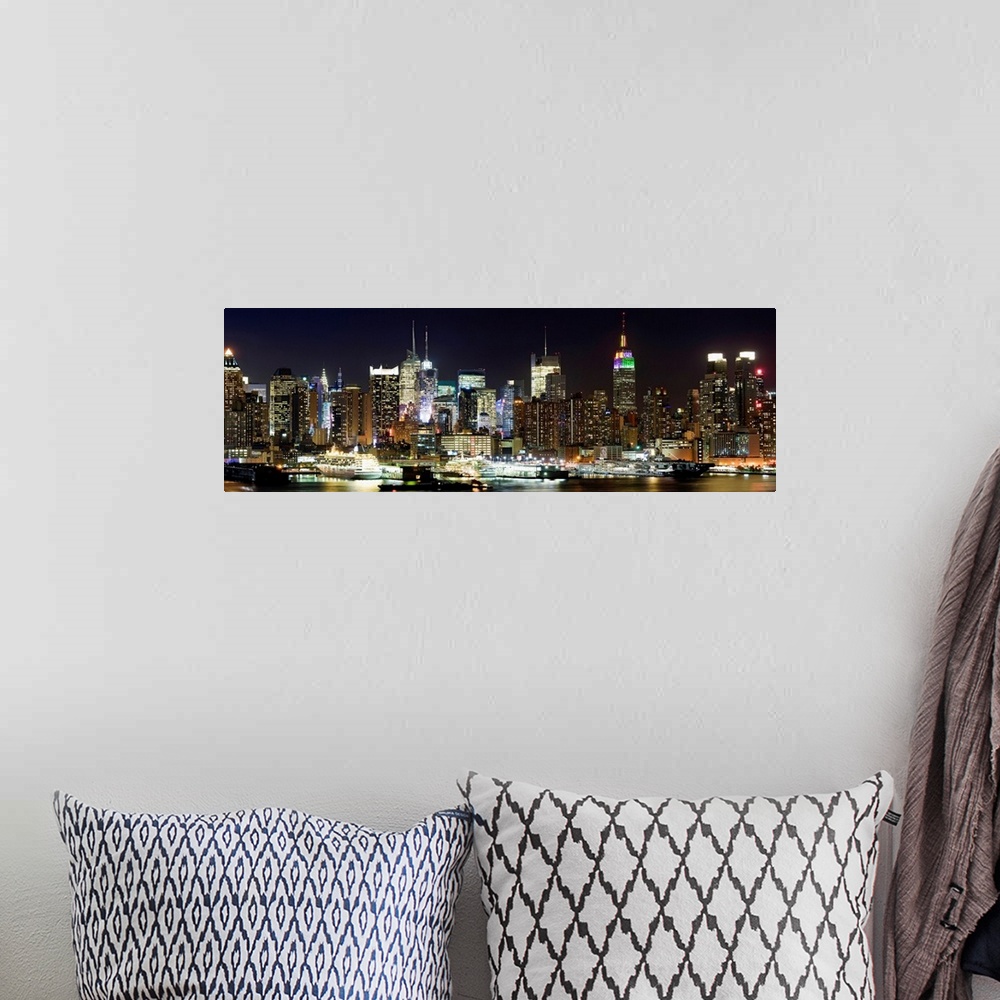 A bohemian room featuring Oversized panoramic photograph of brightly lit skyscrapers in Manhattan, behind the reflecting wa...