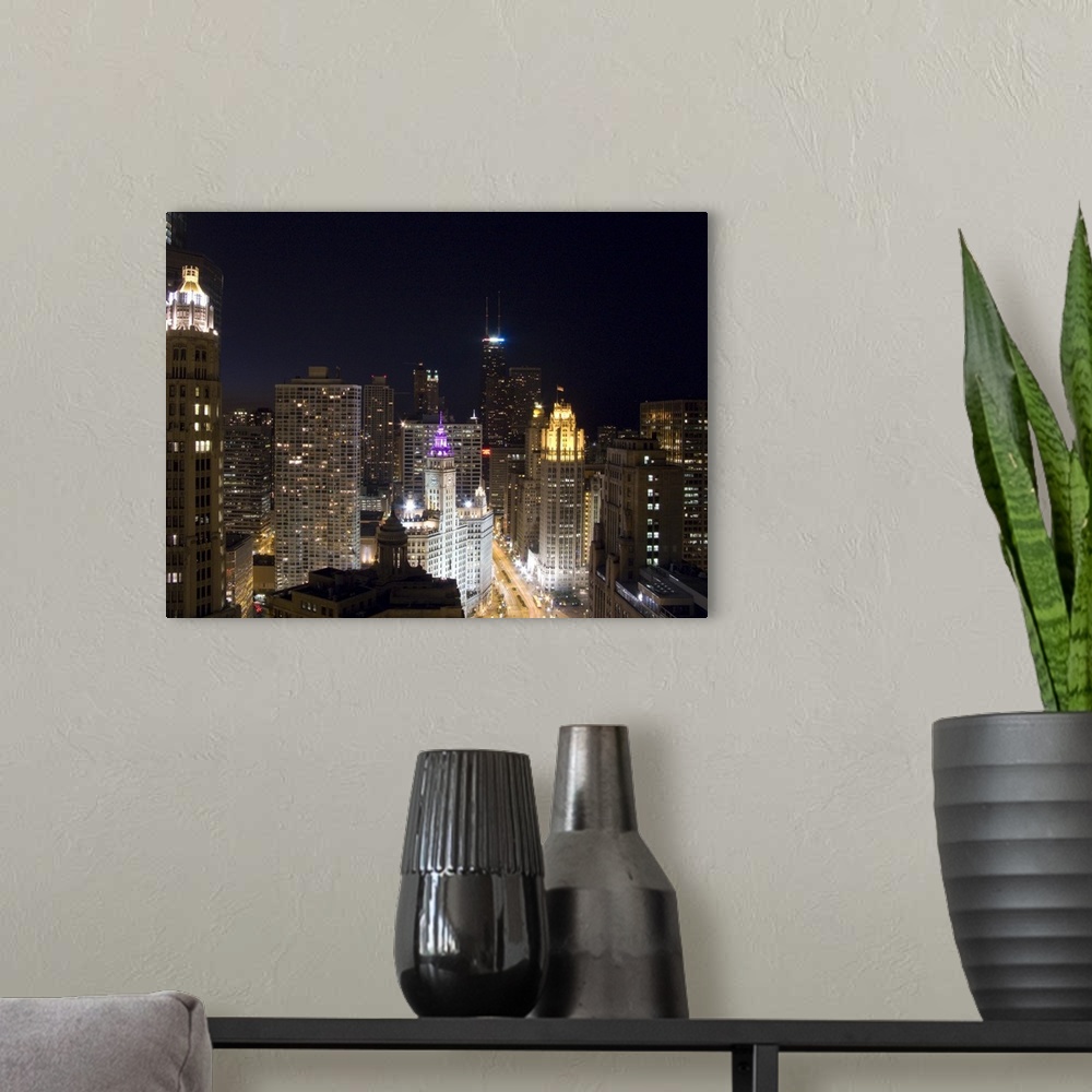 A modern room featuring Large photograph of downtown Chicago, Illinois (IL) lit up at night featuring the Magnificent Mil...