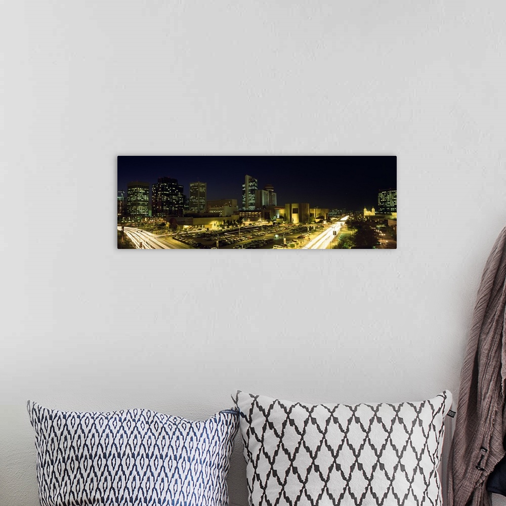 A bohemian room featuring Panoramic canvas of buildings in Phoenix illuminated at night.