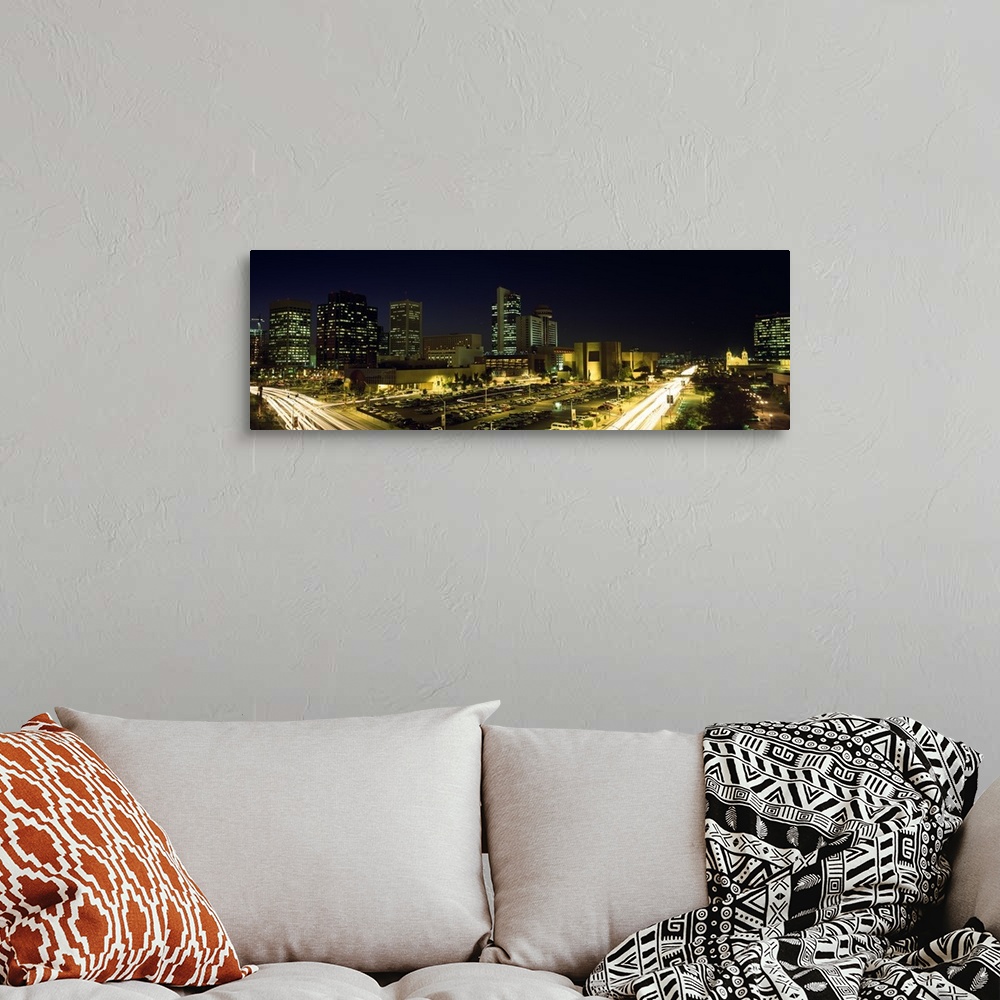 A bohemian room featuring Panoramic canvas of buildings in Phoenix illuminated at night.