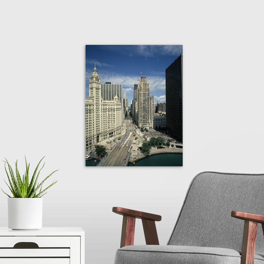 A modern room featuring A large vertical piece of a bridge and street running through tall buildings in the city of Chicago.
