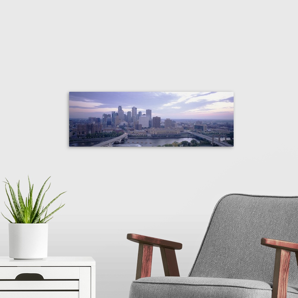 A modern room featuring Large panoramic picture of downtown Minneapolis sitting on the banks of the Mississippi River.
